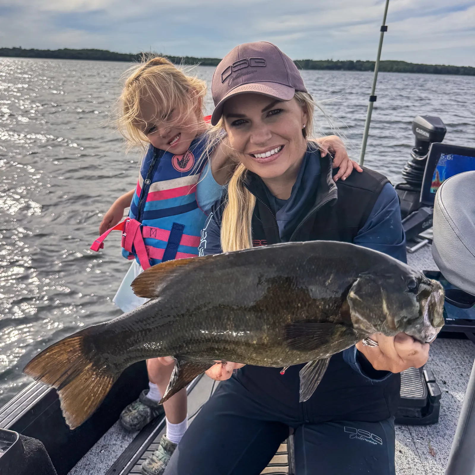 Nicole Stone and her daughter with a smallmouth bass caught on Big Turtle Lake at Kohl’s Resort in northern Minnesota